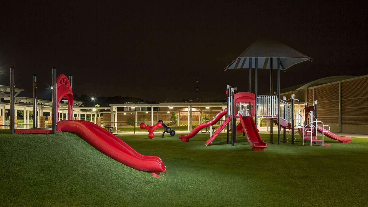 Nighttime artificial turf playground by Southwest Greens East Bay